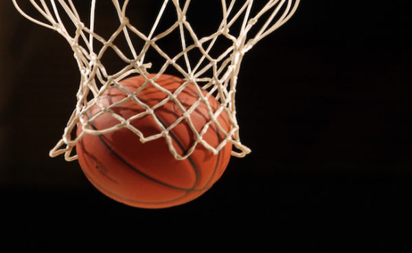 Black background, basketball net with a basketball 