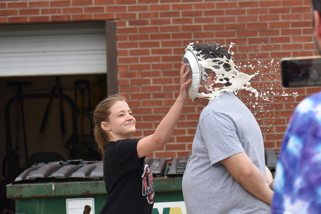Student throwing a pie in Dr. Fitzgerald's face