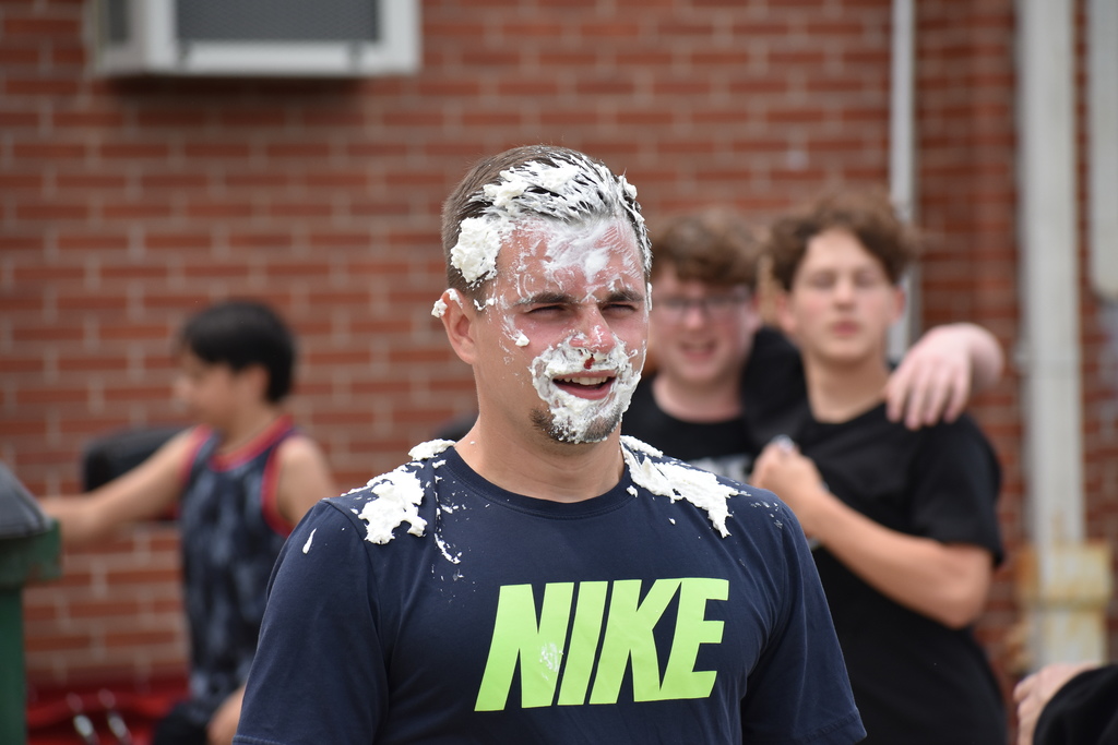 Mr. Hauser poses with whipped cream on his face after a student threw a pie at him