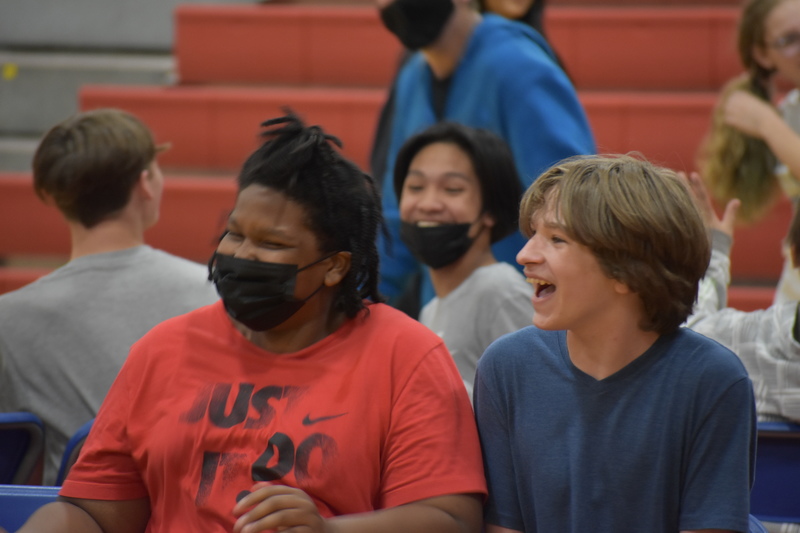 Students laugh together as they play musical chairs in the large gym during Charity Fest